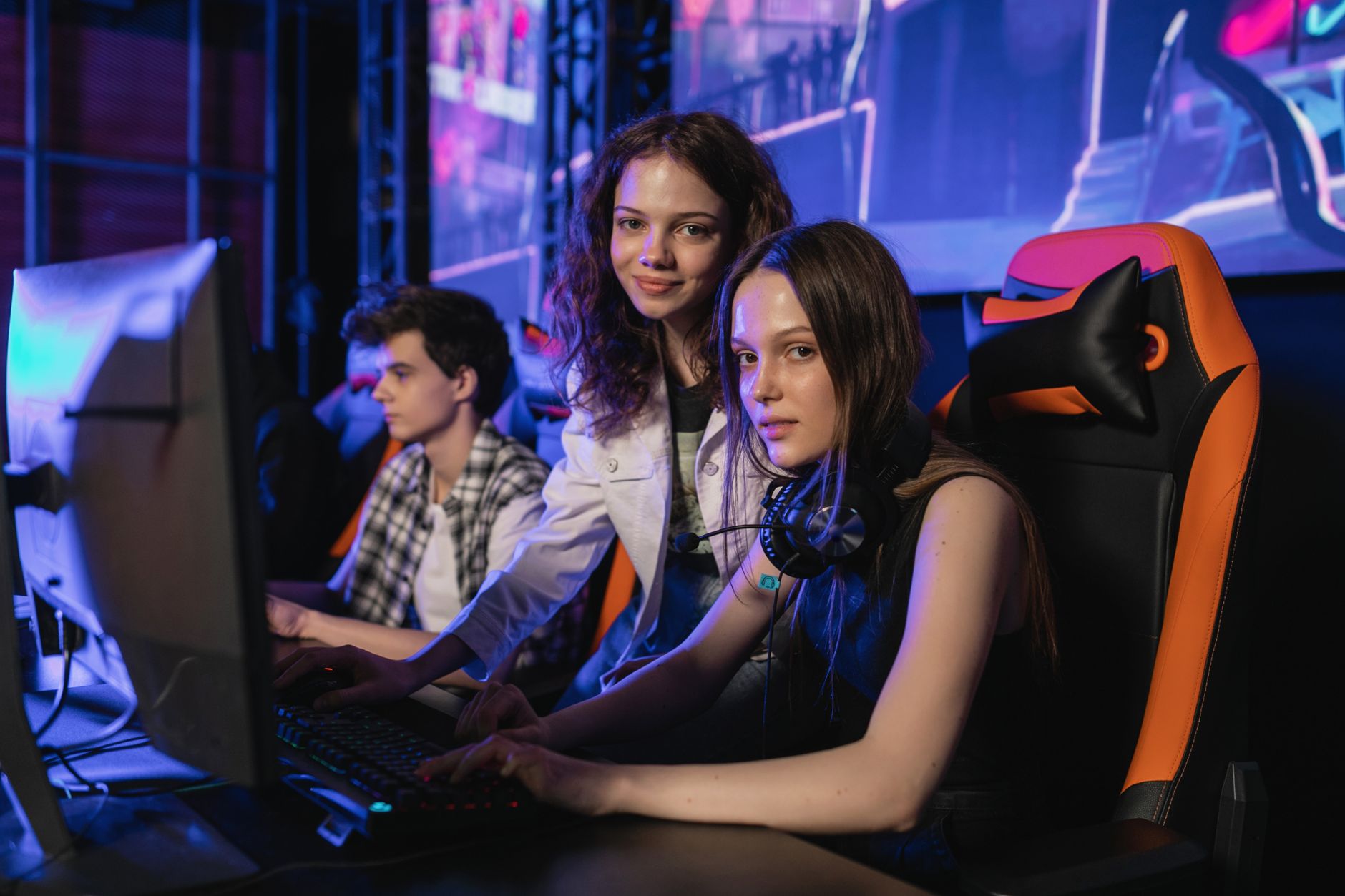 photograph of girls near a monitor